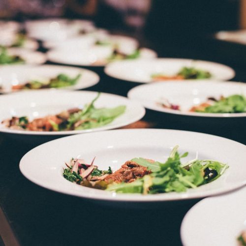 Dinner dishes being lined up to be served at The Alex Hotel