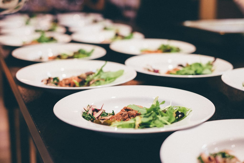 Dinner dishes being lined up to be served at The Alex Hotel