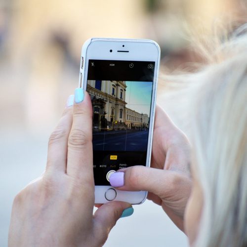 A guest taking pictures near the Alex Hotel