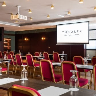 Tables set up for a meeting at The Alex Hotel